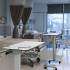 General view of patient room with beds and medical equipment at hospital. Hospital, medicine and healthcare.