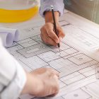 Close-up view of the engineers' plans being discussed. with architect equipment architect on desk Successful teamwork concept